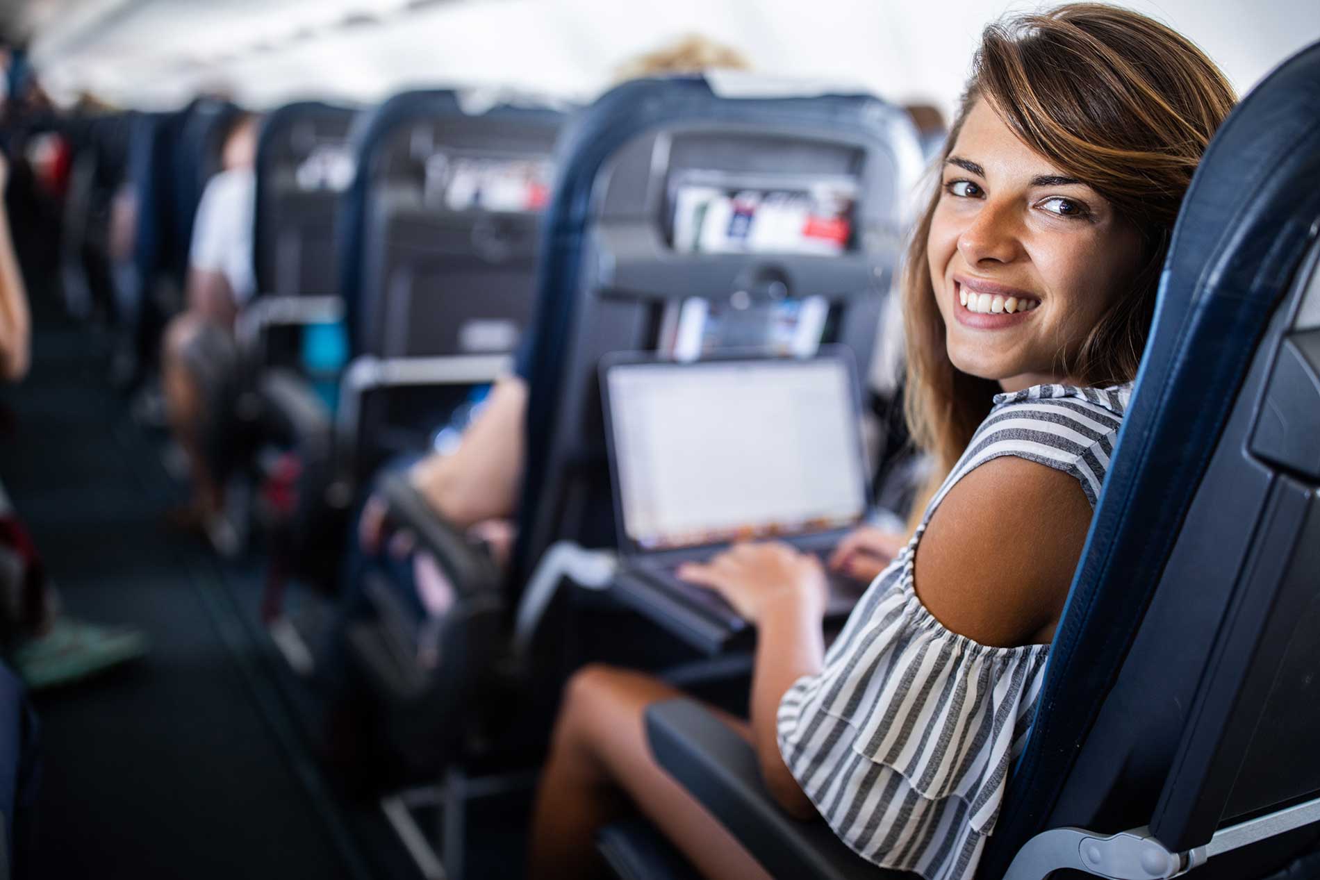 A happy woman relaxing on an airplane
